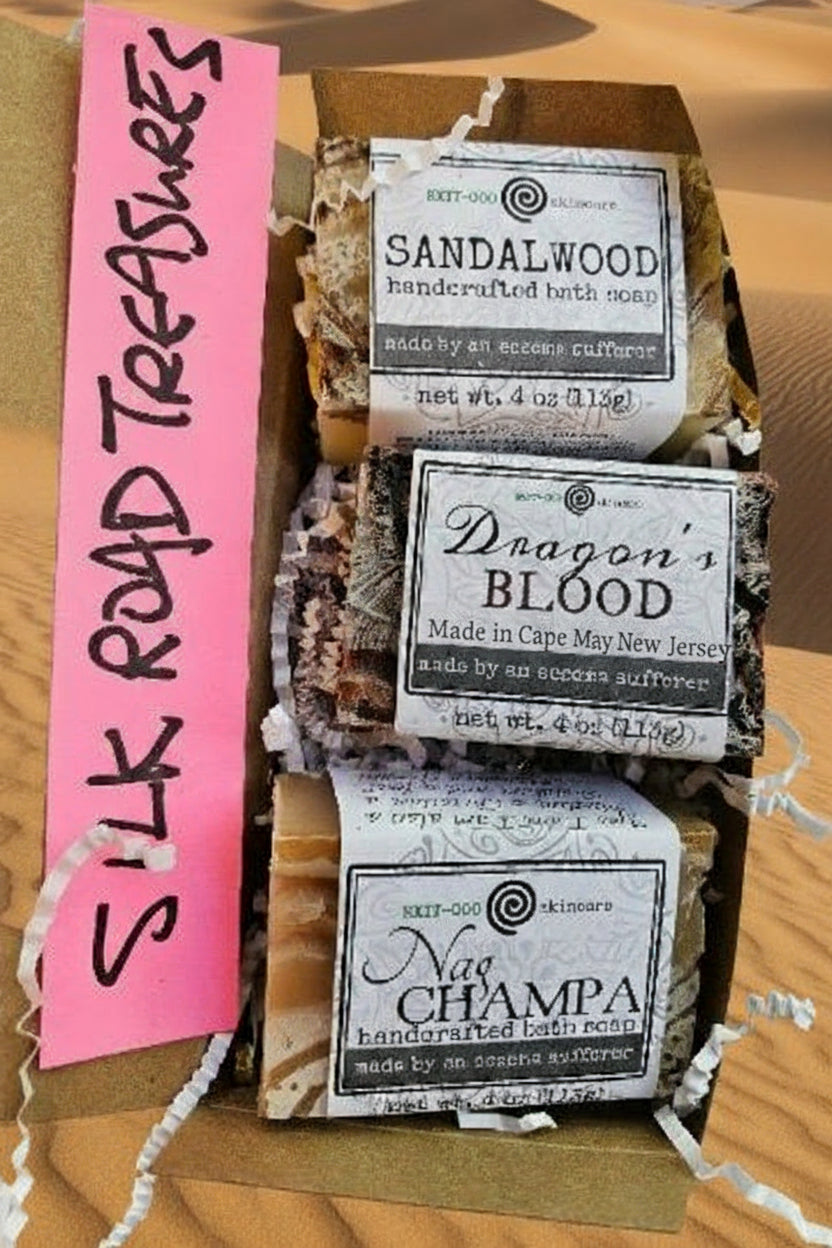 Three bars of soap with labels on a cardboard box, labeled 'Silk Road Treasures'.