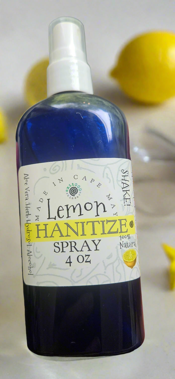 Bottle of lemon hand sanitizer spray held by a person