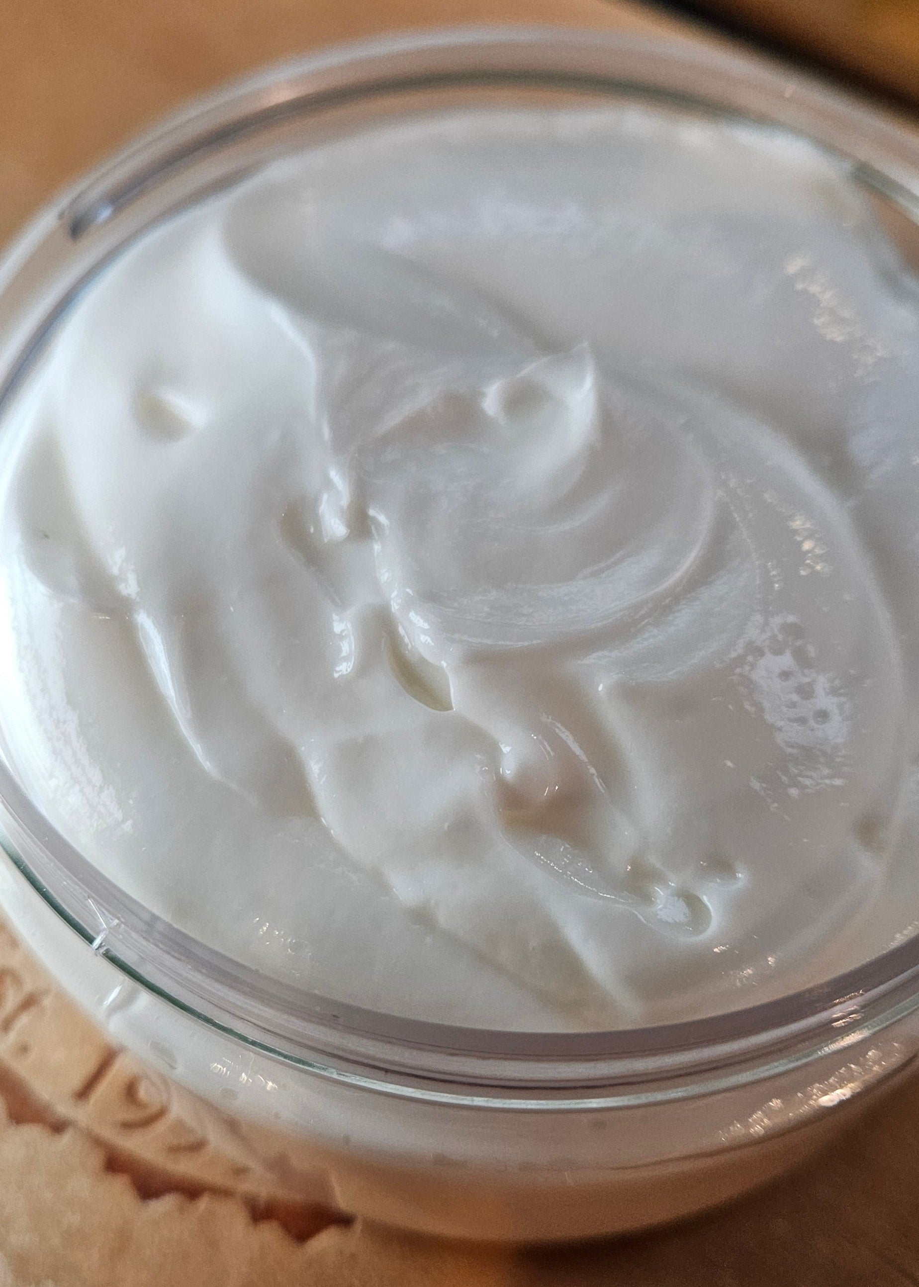 Close-up of a container with white cream on a brown surface