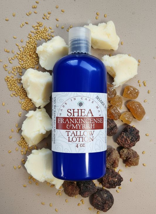 Bottle of Shea Frankincense & Myrrh Tallow Lotion surrounded by natural ingredients on a textured surface.