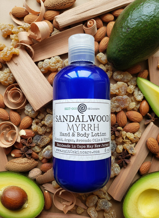 Blue bottle of Sandalwood Myrrh lotion on a wooden surface