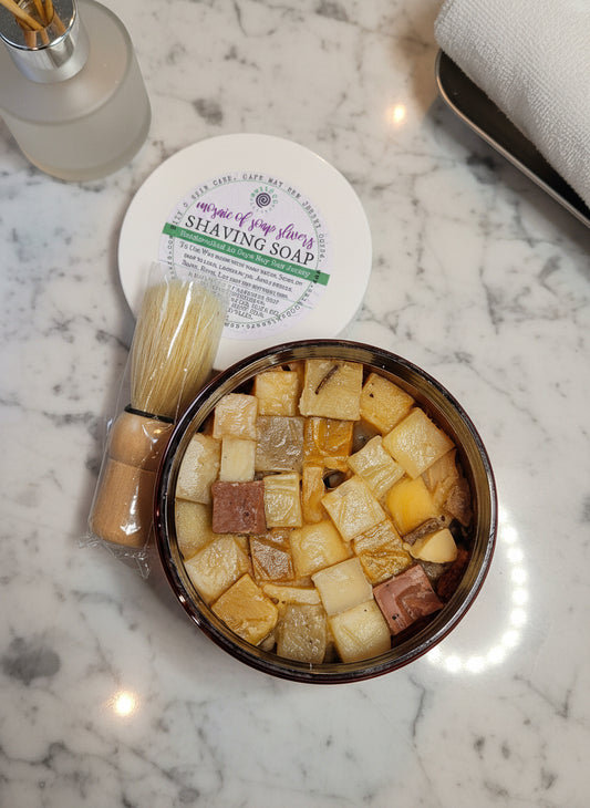 Shaving soap, brush, and soap cubes on a marble surface