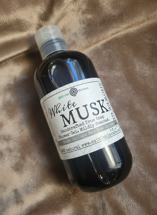 Bottle of White Musk shower gel on a wooden surface