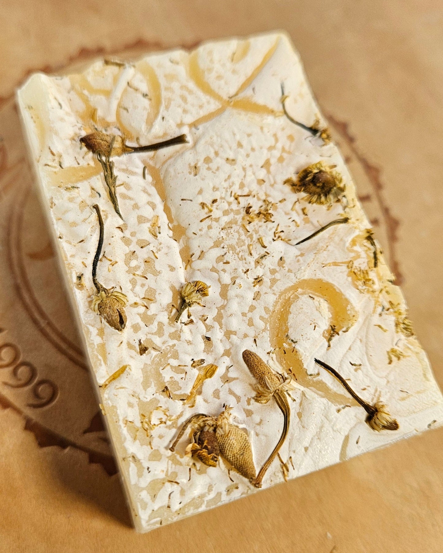 Decorative stone with gold leaf on a brown surface