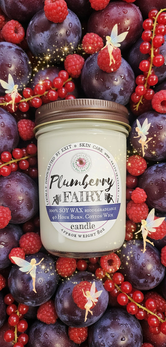 Jar of Plumberry wax candle on a textured surface with stones.