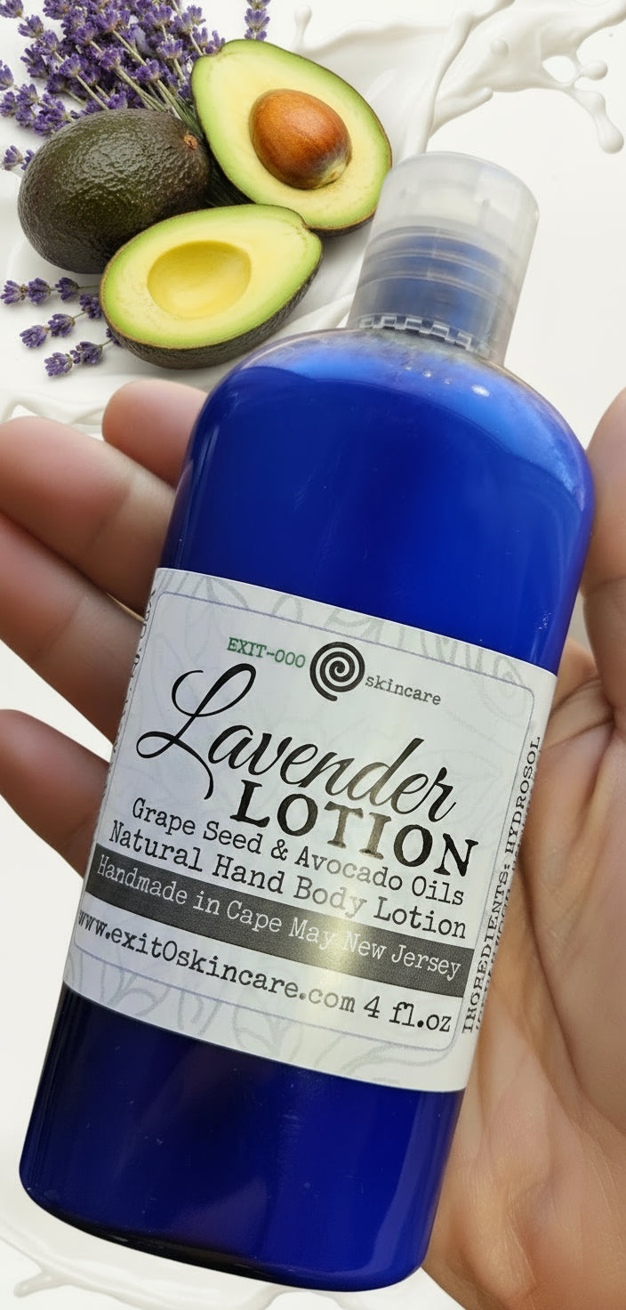 Blue bottle of lavender lotion held in a hand with a blurred background