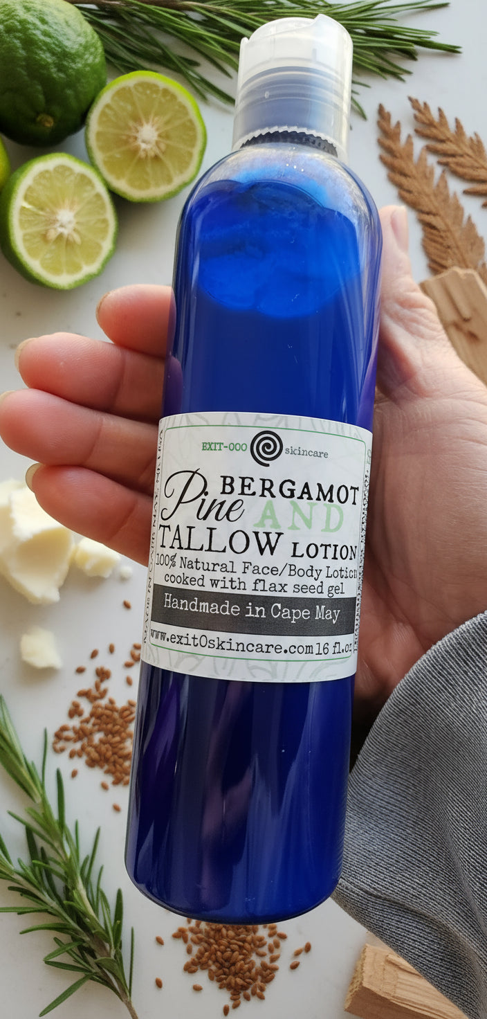 A blue bottle of lotion labeled 'Bergamot Pine Tallow Lotion' held in a person's hand.