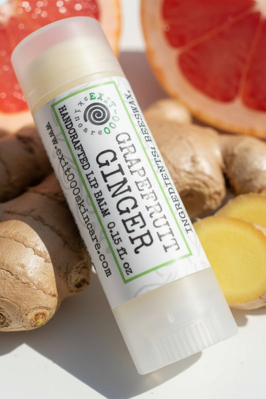 A stick of lip balm labeled 'Grapefruit Ginger' with a green and white color scheme.