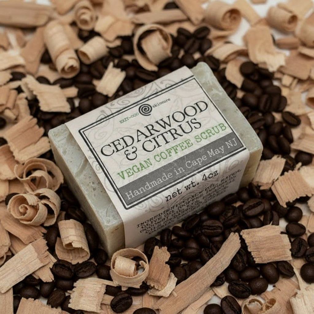 A packaged bar of cedarwood and citrus vegan coffee scrub soap, with visible ground coffee and labeling.